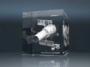 Glass cube with a 3D laser engraving of a satellite and Hubble 25 lettering