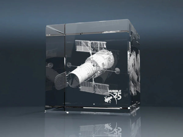 Glass cube with a 3D laser engraving of a satellite and Hubble 25 lettering