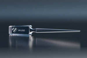 Premium crystal glass letter opener with an engraved logo on a dark background