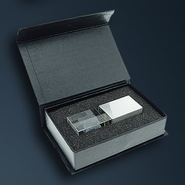 Schwarze Magnetklappbox mit Schaumstoffeinlage und USB-Stick aus Glas und Metall