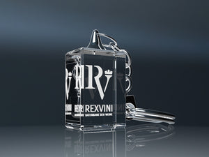 Glass keyring with 3D engraving and a metal ring against a dark background