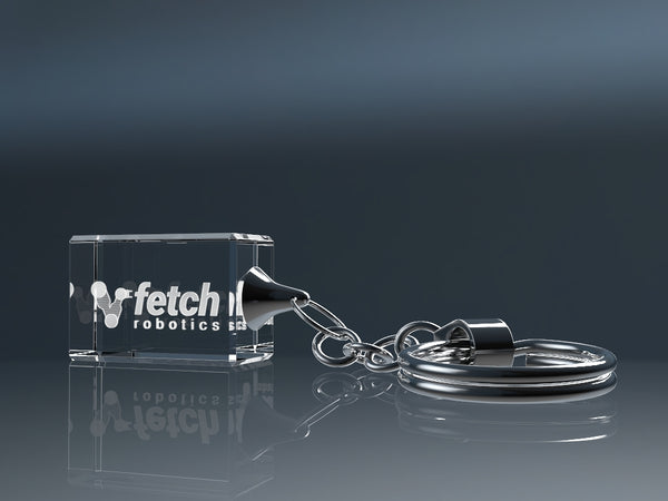 Rectangular engraved crystal glass keyring on a reflective surface