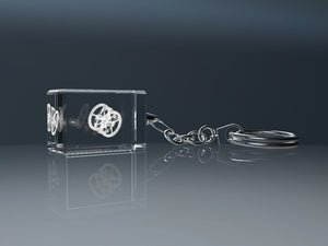 Engraved crystal glass keyring reflected on a glossy surface