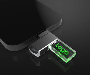 Crystal glass USB-C drive with an engraved logo connected to a smartphone